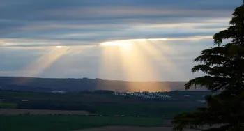 Gods rays on a cloudy spring evening over a solar farm.jpg